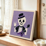 Rocker skeleton punch needle artwork displayed on a table