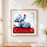 Finished romantic bear holding a red heart cross stitch artwork displayed