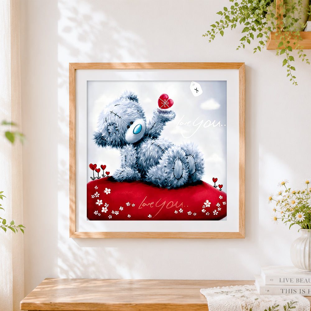 Finished romantic bear holding a red heart cross stitch artwork displayed