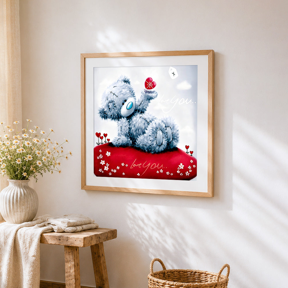 Romantic bear holding a red heart cross stitch artwork displayed on wall as home decor