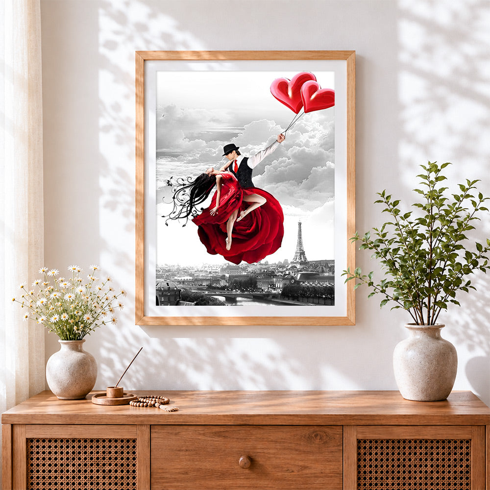 Finished romantic couple flying in paris cross stitch artwork displayed