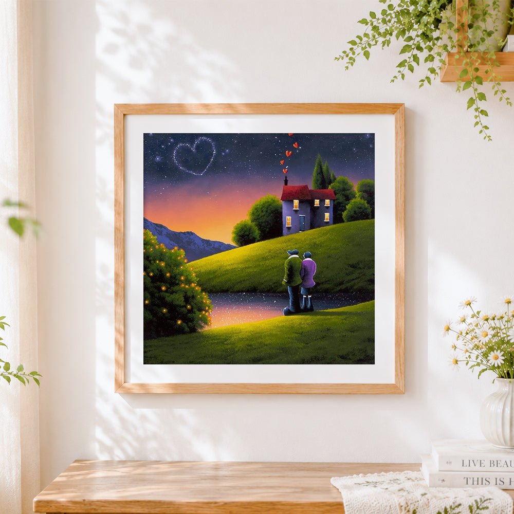 Finished romantic couple under a heart shaped sky cross stitch artwork displayed