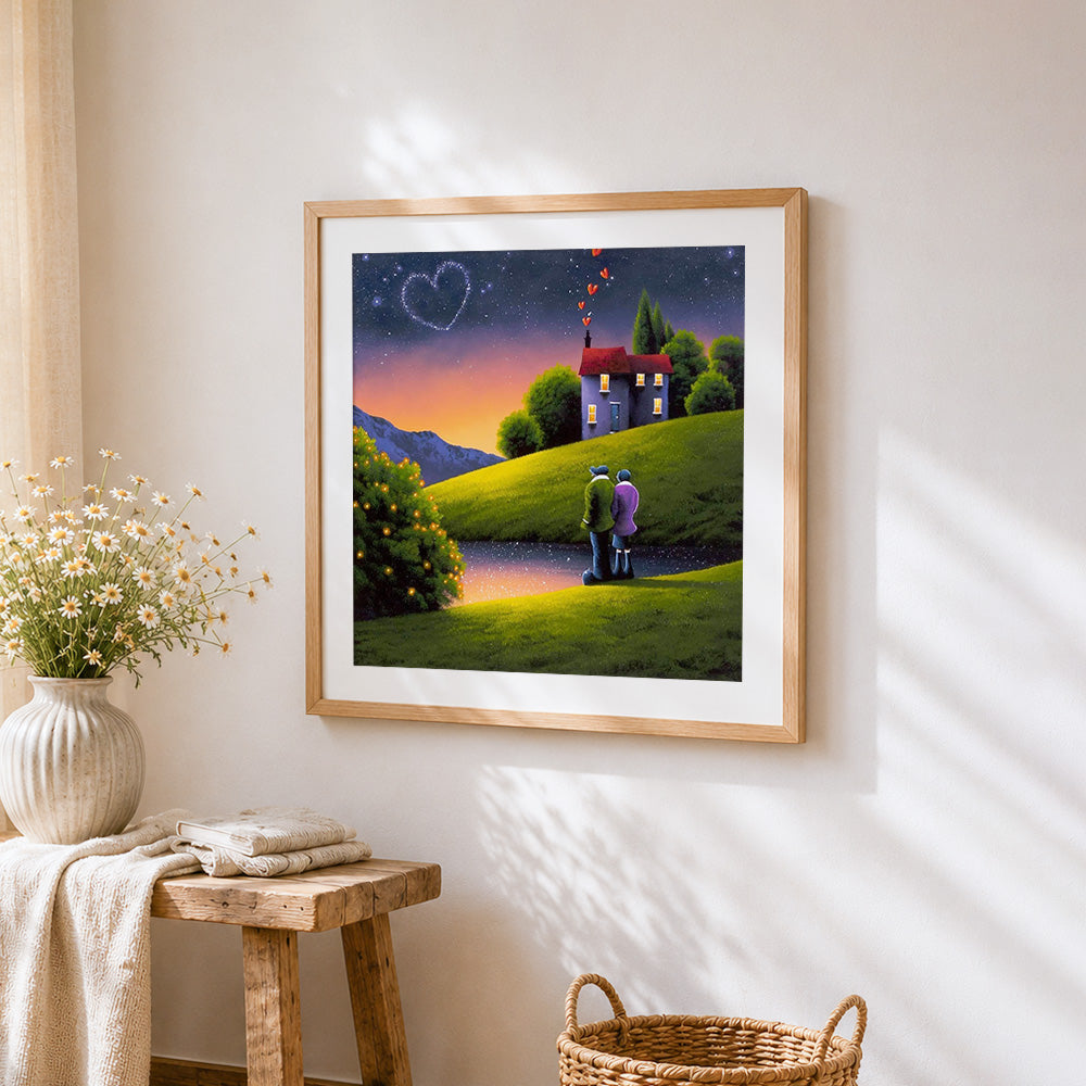 Romantic couple under a heart shaped sky cross stitch artwork displayed on wall as home decor