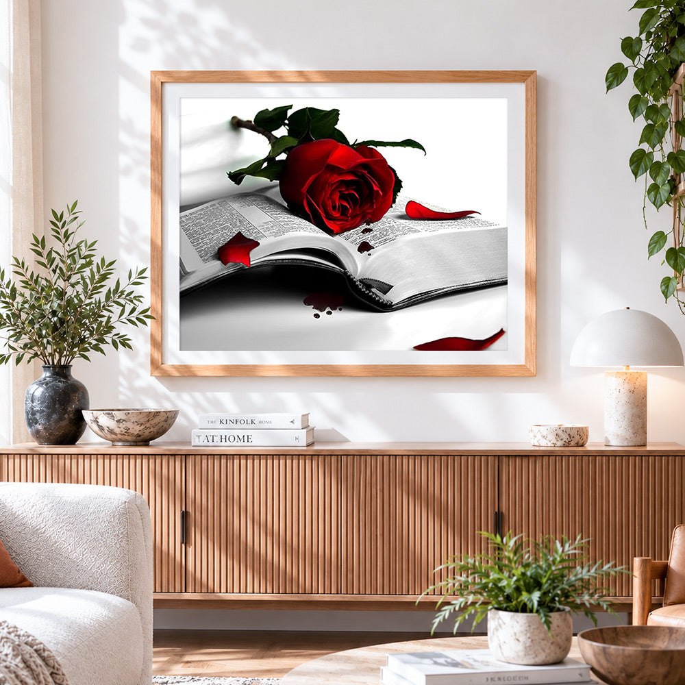 Finished romantic red rose on an open book cross stitch artwork displayed