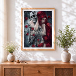 Finished romantic skeleton and red-haired woman cross stitch artwork displayed