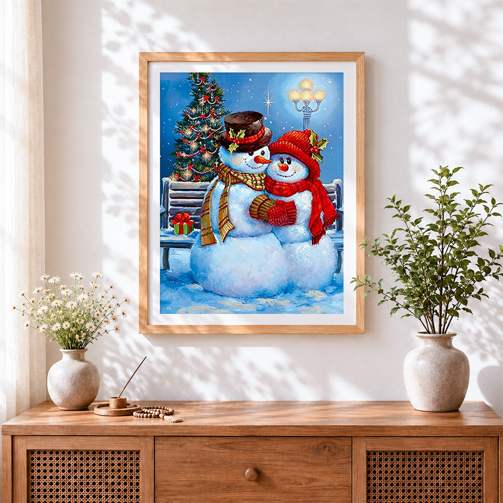 Finished romantic snowman couple cuddling by a lamppost cross stitch artwork displayed