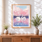 Finished romantic swans and cherry blossom cross stitch artwork displayed