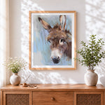Finished rustic donkey cross stitch artwork displayed