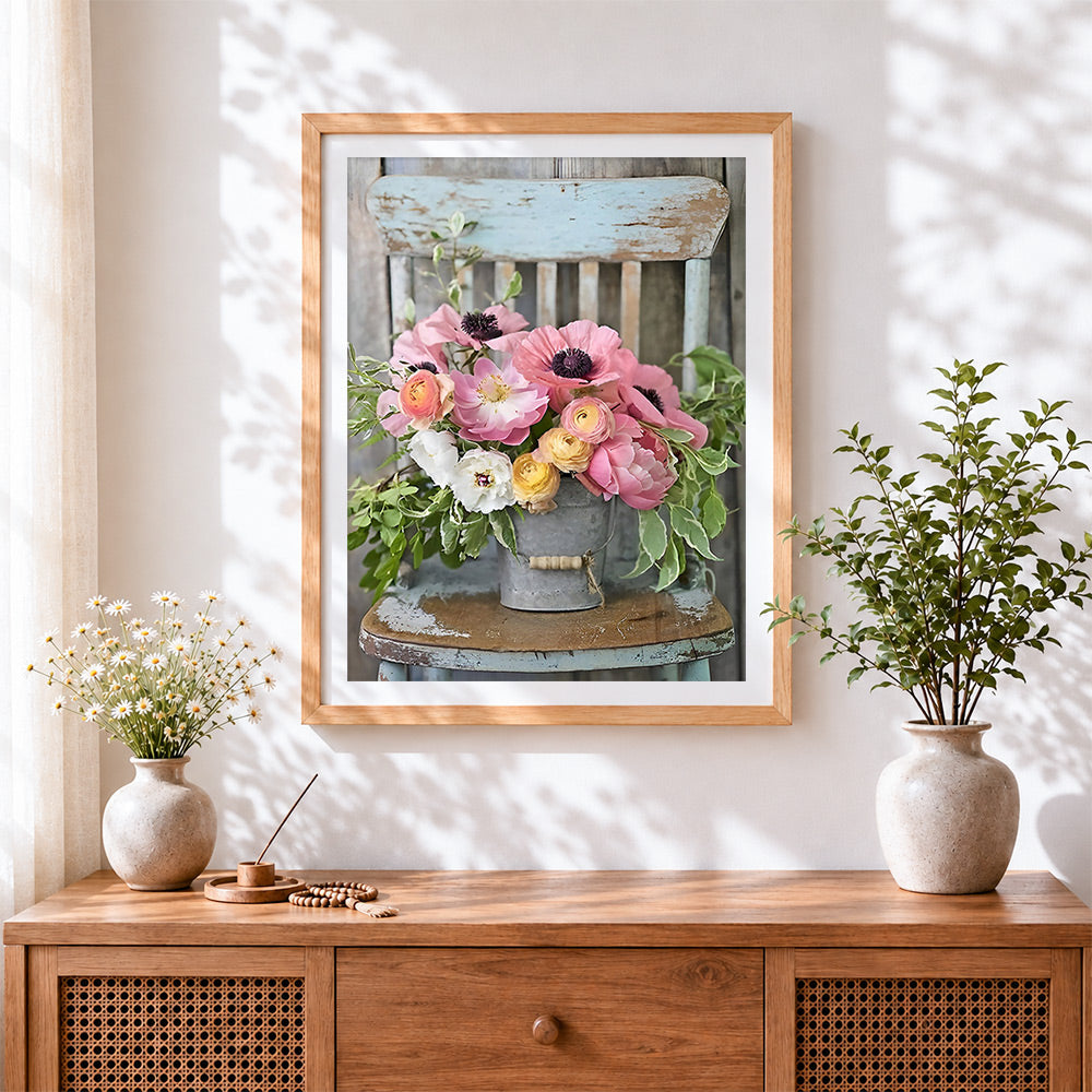 Finished rustic flower bucket on chair cross stitch artwork displayed