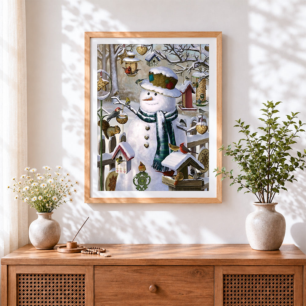 Finished rustic snowman and bird feeder cross stitch artwork displayed