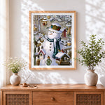 Finished rustic snowman and bird feeder cross stitch artwork displayed