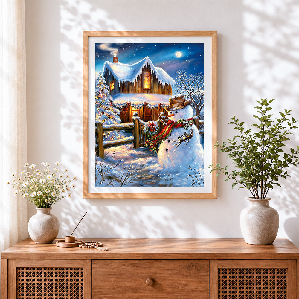 Finished rustic snowman by a cosy log cabin cross stitch artwork displayed