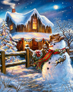 Rustic snowman by a cosy log cabin cross stitch kit for beginners