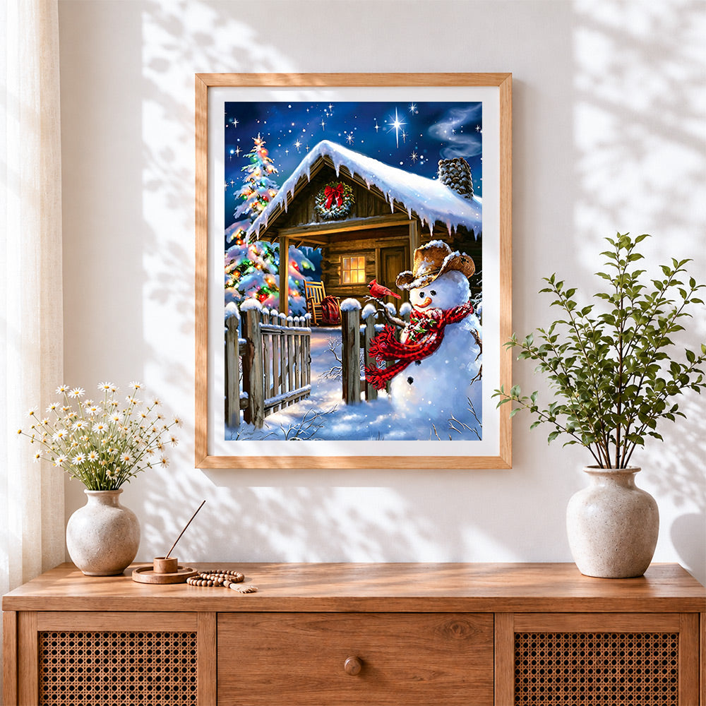 Finished rustic snowman by a snowy log cabin cross stitch artwork displayed