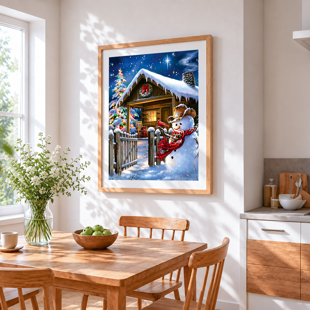 Rustic snowman by a snowy log cabin cross stitch artwork displayed on wall as home decor