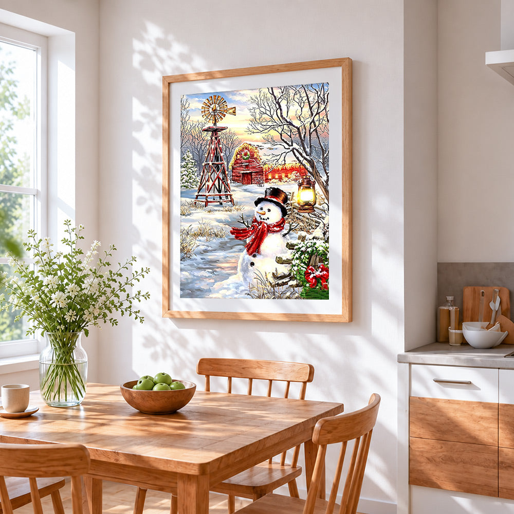 Rustic snowman with windmill and red barn cross stitch artwork displayed on wall as home decor