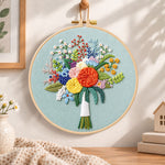 Sage green floral bouquet embroidery hoop wall art displayed as warm and cosy handmade home decor