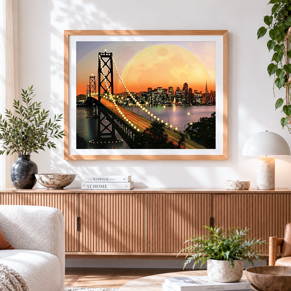 Finished san francisco bay bridge and supermoon cross stitch artwork displayed