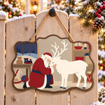 Santa and reindeer bond paint by numbers door hanger on a garden gate