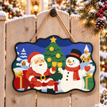 Santa and snowman toast paint by numbers door hanger on a garden gate