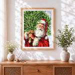 Finished santa carrying a christmas tree cross stitch artwork displayed