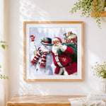Finished santa claus and snowman with gift sack cross stitch artwork displayed