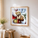 Santa claus holding a golden puppy cross stitch artwork displayed on wall as home decor
