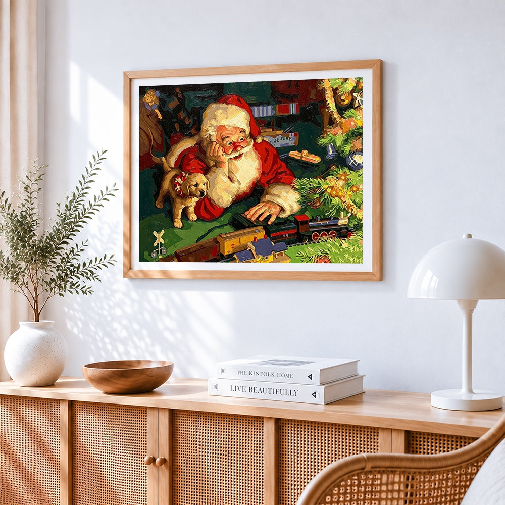 Santa claus playing with toy train cross stitch artwork displayed on wall as home decor