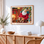 Santa claus relaxing by the fire with cat cross stitch artwork displayed on wall as home decor