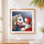 Finished santa claus with a white horse cross stitch artwork displayed