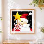 Finished santa claus holding a golden star cross stitch artwork displayed