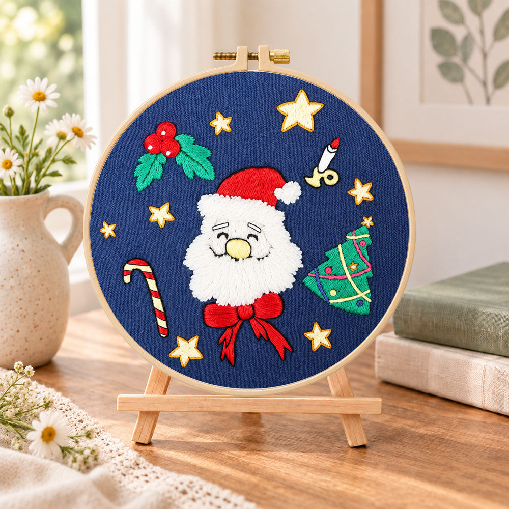 Santa face design embroidery kit finished hoop displayed on a wooden stand as cosy tabletop decor
