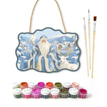 Santa in snowy village paint by numbers door hanger with paints and brushes