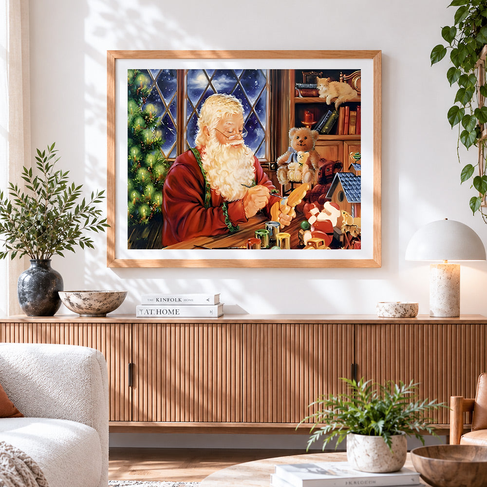 Finished santa painting toys in workshop cross stitch artwork displayed