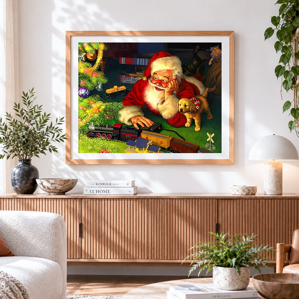 Finished santa playing with toy train and puppy cross stitch artwork displayed
