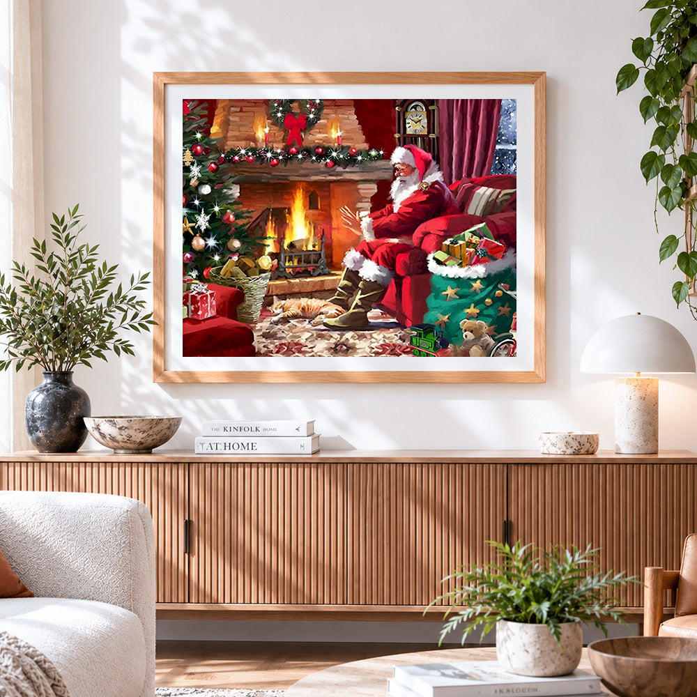 Finished santa relaxing by the fire with cat cross stitch artwork displayed