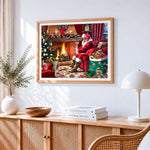 Santa relaxing by the fire with cat cross stitch artwork displayed on wall as home decor