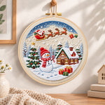 Santa sleigh winter village embroidery hoop wall art displayed as warm and cosy handmade home decor