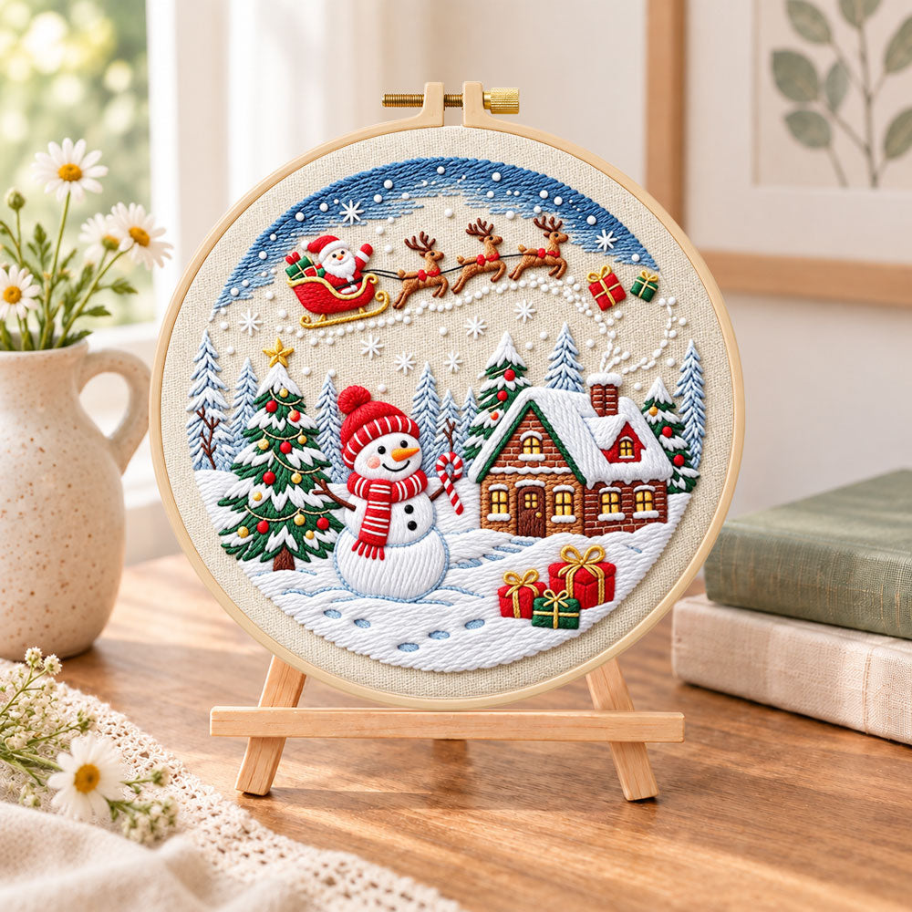 Santa sleigh winter village embroidery kit finished hoop displayed on a wooden stand as cosy tabletop decor