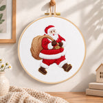 Santa with gift sack embroidery hoop wall art displayed as warm and cozy handmade home decor