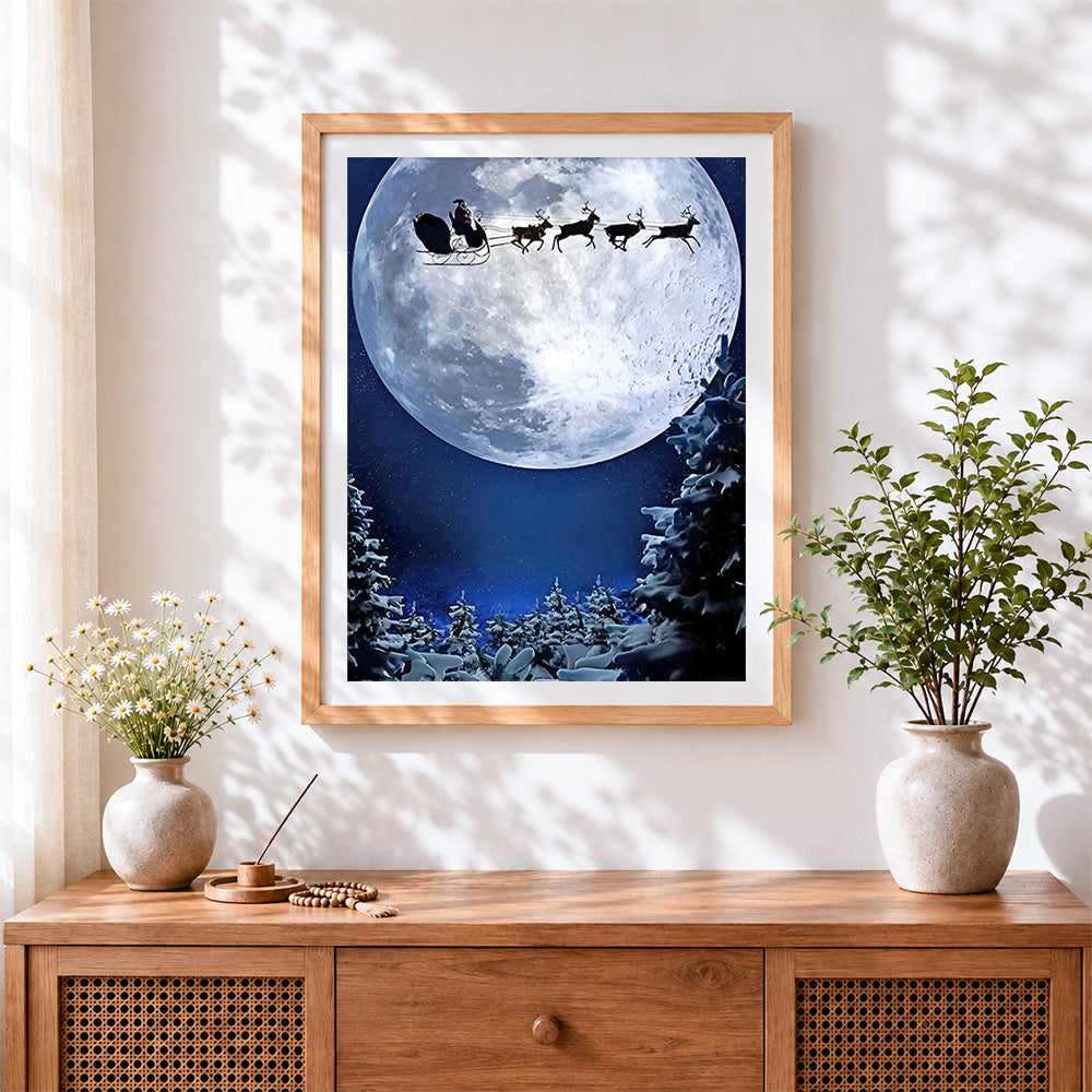Finished santa's sleigh flying across a full moon silhouette cross stitch artwork displayed