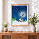 Finished santa's sleigh flying over a snowy cottage cross stitch artwork displayed