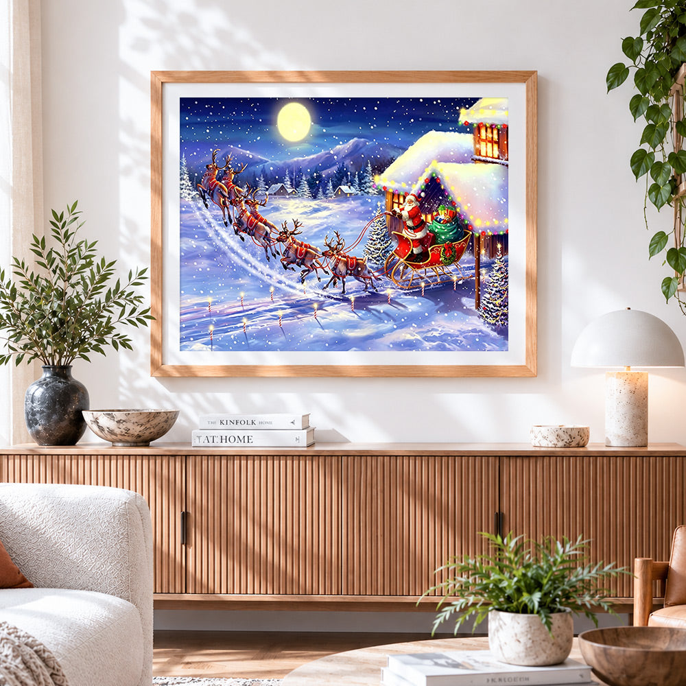 Finished santa's sleigh flying over snowy mountains cross stitch artwork displayed