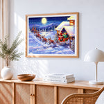 Santa's sleigh flying over snowy mountains cross stitch artwork displayed on wall as home decor