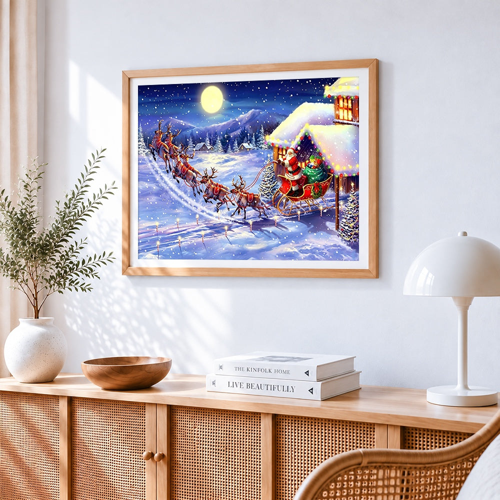 Santa's sleigh flying over snowy mountains cross stitch artwork displayed on wall as home decor