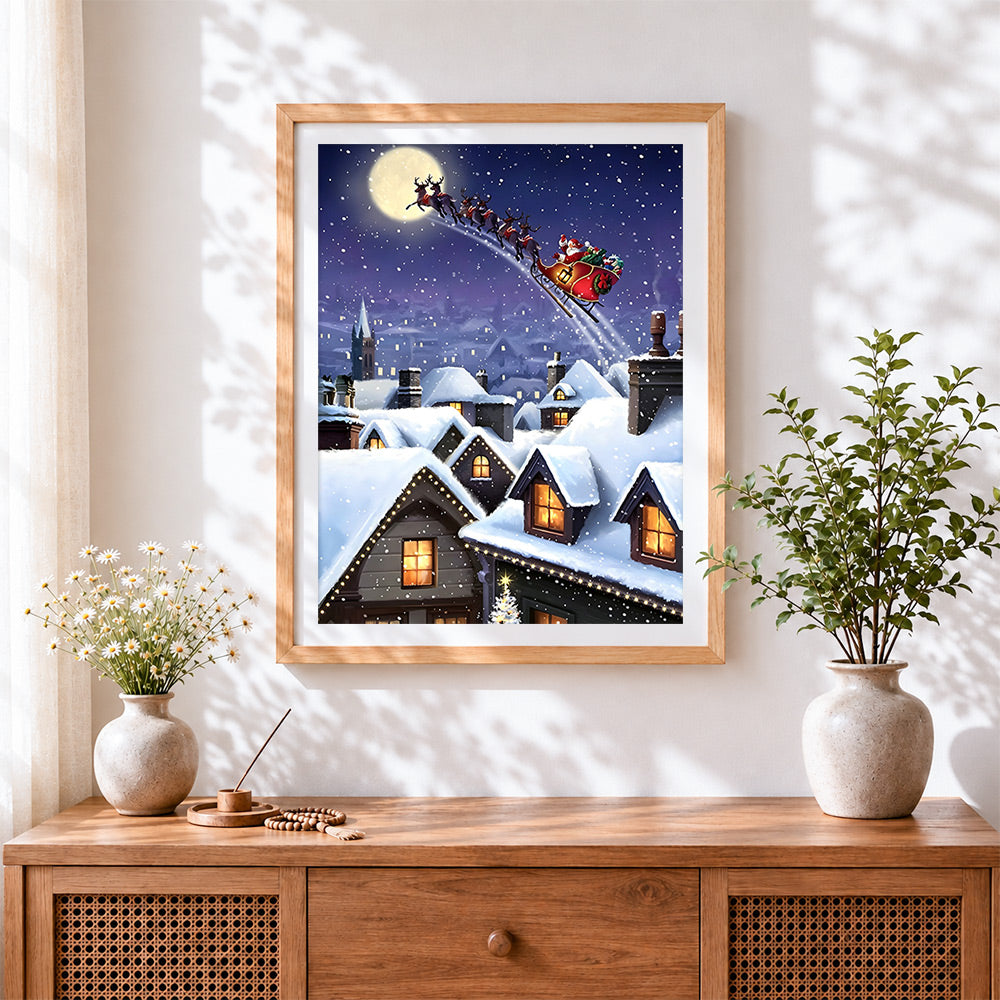 Finished santa's sleigh flying over snowy rooftops cross stitch artwork displayed