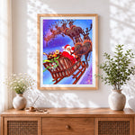 Finished santa's sleigh flying through the sky cross stitch artwork displayed