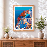 Finished santorini blue domes and cliffs cross stitch artwork displayed