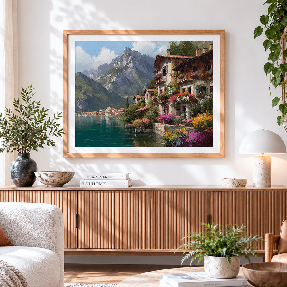 Finished scenic mountain and flowering village cross stitch artwork displayed