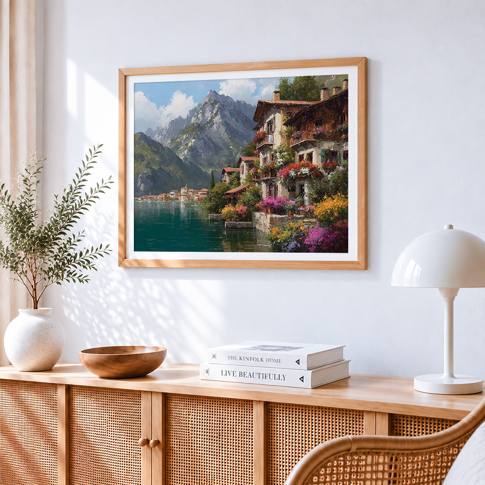 Scenic mountain and flowering village cross stitch artwork displayed on wall as home decor